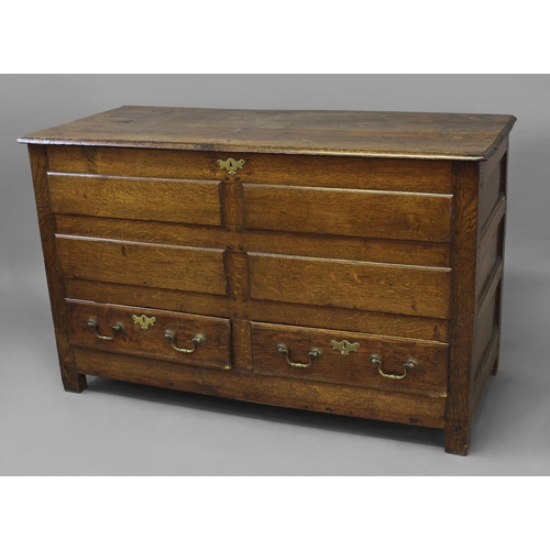 1713 - A LATE 17TH OR EARLY 18TH CENTURY OAK MULE CHEST, The two plank hinged top above above a front with ... 