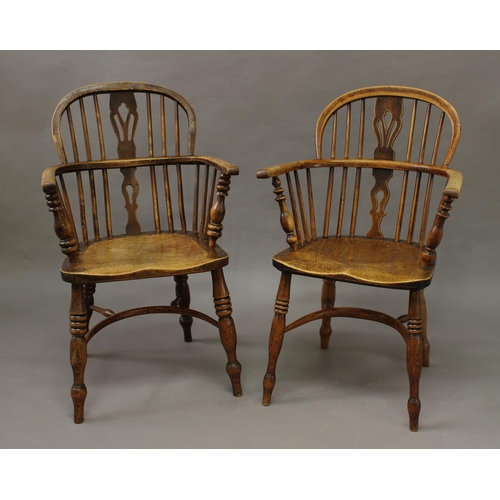 1721 - A NEAR PAIR OF 19TH CENTURY BEECH AND ELM WINDSOR ARM CHAIRS, each with low arched backs with simila... 