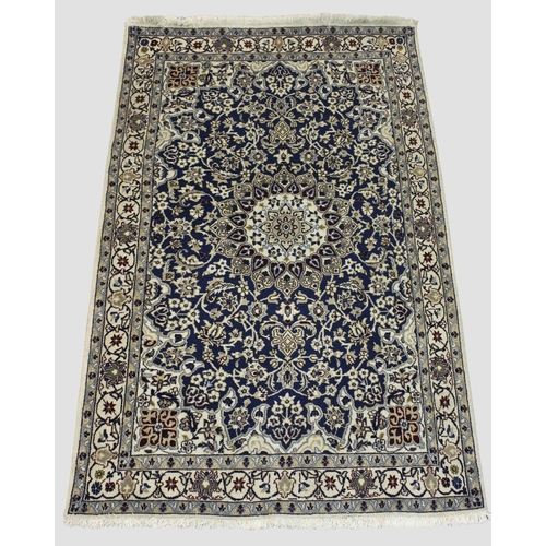 1886 - NAIN RUG,  Central Iran, circa 1970. The indigo field of floral vines around a flower head medallion... 