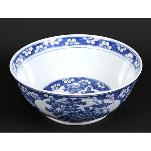 1253 - LARGE CHINESE BOWL a large 19thc blue and white porcelain bowl, the two panels painted with Birds in... 