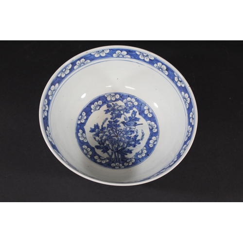 1253 - LARGE CHINESE BOWL a large 19thc blue and white porcelain bowl, the two panels painted with Birds in... 