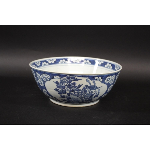 1253 - LARGE CHINESE BOWL a large 19thc blue and white porcelain bowl, the two panels painted with Birds in... 