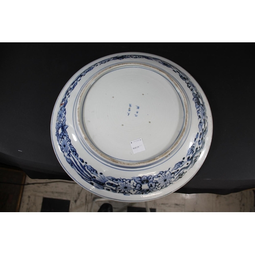 1261 - LARGE 19THC JAPANESE IMARI DISH the centre painted with a mythical animal within a blue and white ci... 