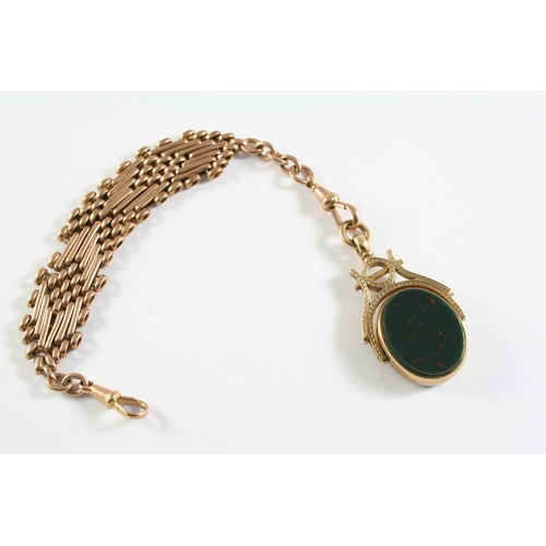 729 - A BLOODSTONE AND BLACK ONYX SPINNING FOB in a 9ct gold mount and suspended from a 15ct gold fancy li... 