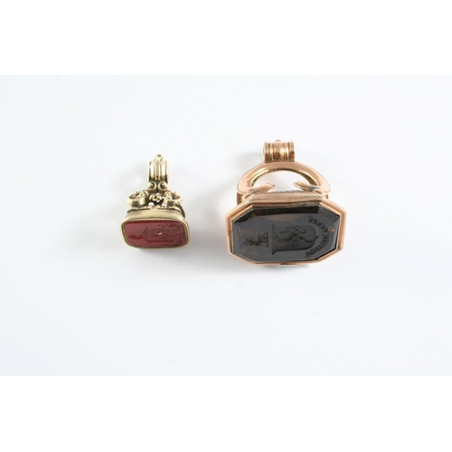 730 - A GOLD SEAL mounted with a smoky quartz matrix carved with a crest, 4cm high, together with a gold s... 