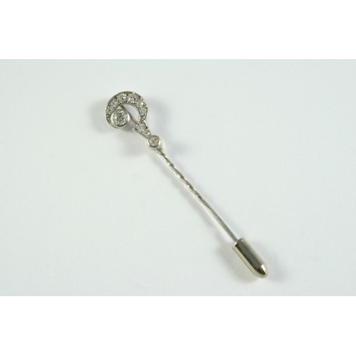 742 - A DIAMOND QUESTION MARK STICK PIN mounted with two collet set old circular-cut diamonds and millegra... 