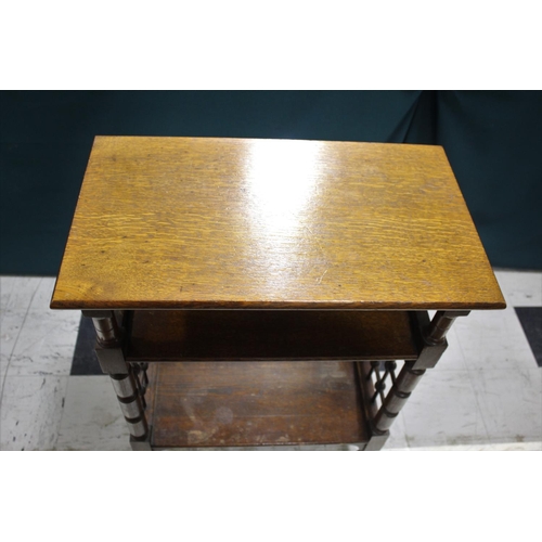 1028 - LIBERTY & CO SIDE TABLE An oak three tier table of Moorish influence, with a rectangular flat top an... 