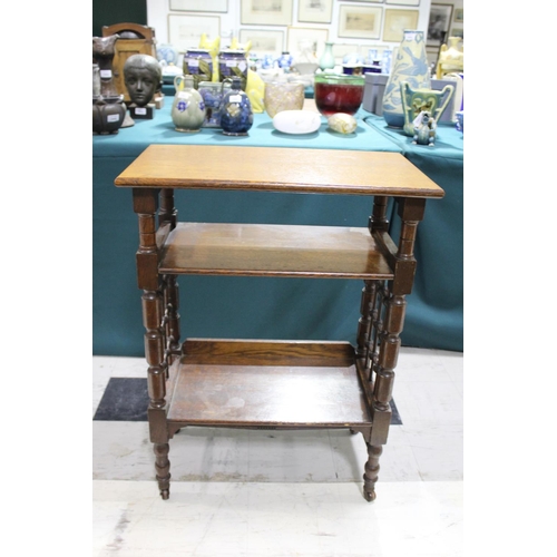 1028 - LIBERTY & CO SIDE TABLE An oak three tier table of Moorish influence, with a rectangular flat top an... 