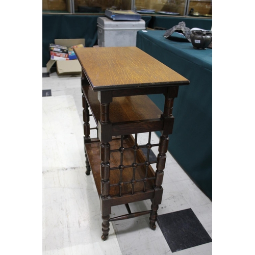 1028 - LIBERTY & CO SIDE TABLE An oak three tier table of Moorish influence, with a rectangular flat top an... 