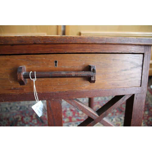 1021 - ARTS & CRAFTS SIDE TABLE an unusual table with two drawers and bar handles, supported on eight legs ... 