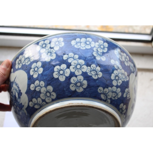 1253 - LARGE CHINESE BOWL a large 19thc blue and white porcelain bowl, the two panels painted with Birds in... 