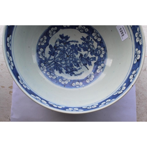 1253 - LARGE CHINESE BOWL a large 19thc blue and white porcelain bowl, the two panels painted with Birds in... 