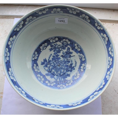 1253 - LARGE CHINESE BOWL a large 19thc blue and white porcelain bowl, the two panels painted with Birds in... 