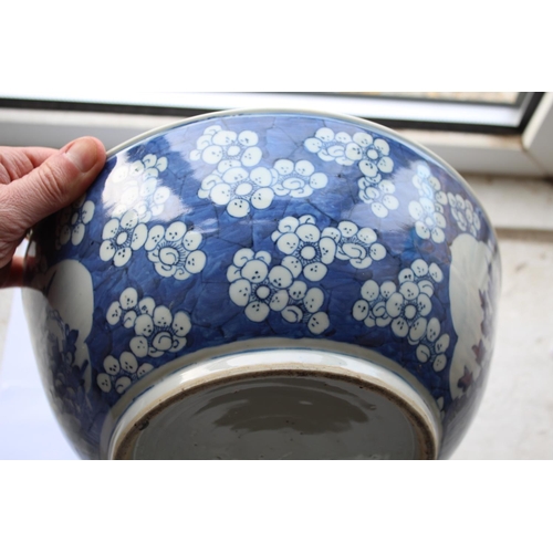 1253 - LARGE CHINESE BOWL a large 19thc blue and white porcelain bowl, the two panels painted with Birds in... 