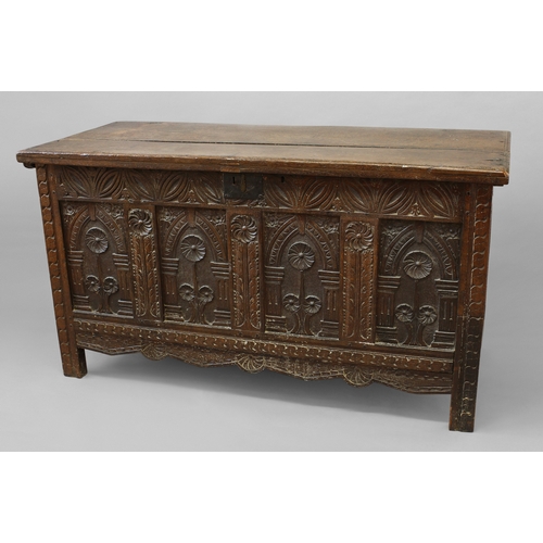 1732 - AN OAK COFFER WITH CARVED FOUR PANEL FRONT, late 17th/early 18th century with a two plank top enclos... 