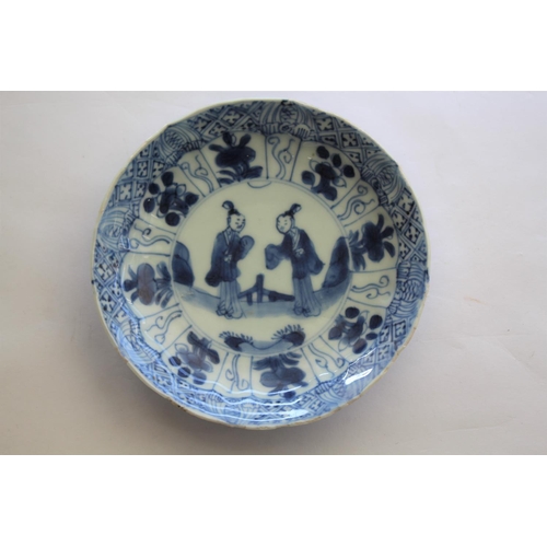 1257 - CHINESE BLUE & WHITE SAUCER a small blue and white saucer painted with various figures including one... 