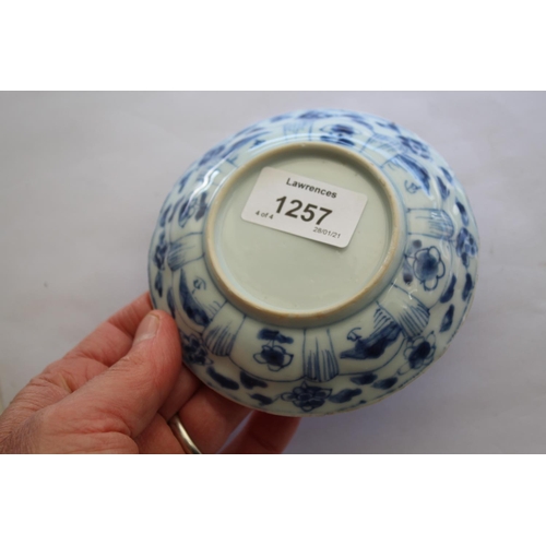 1257 - CHINESE BLUE & WHITE SAUCER a small blue and white saucer painted with various figures including one... 