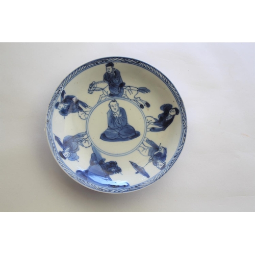 1257 - CHINESE BLUE & WHITE SAUCER a small blue and white saucer painted with various figures including one... 