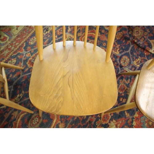 1007 - ERCOL DINING CHAIRS a set of four vintage light elm and beech stick back chairs (two carvers and two... 