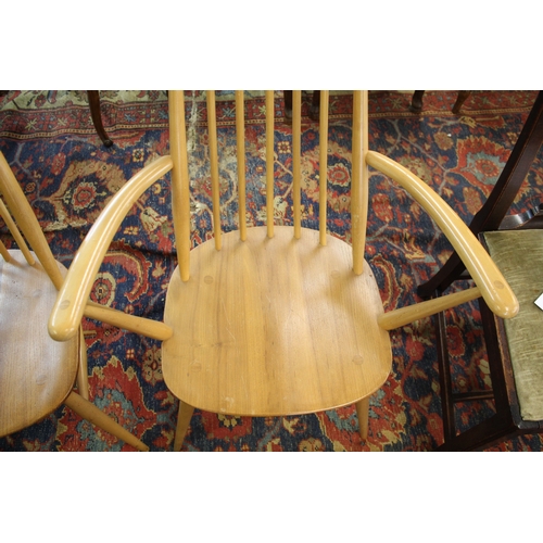 1007 - ERCOL DINING CHAIRS a set of four vintage light elm and beech stick back chairs (two carvers and two... 