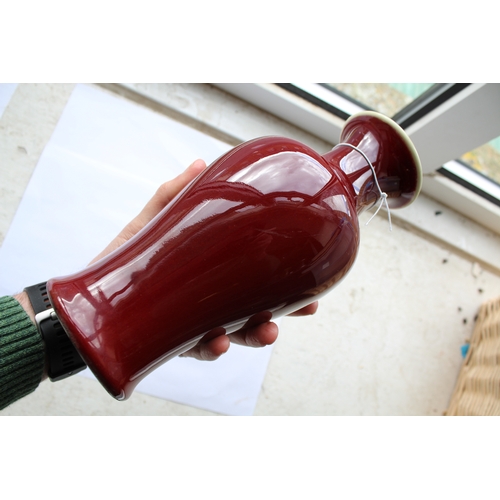 1260 - CHINESE SANG DE BOEUF VASE a porcelain baluster vase with an ox blood red glaze, unmarked (24cms hig... 