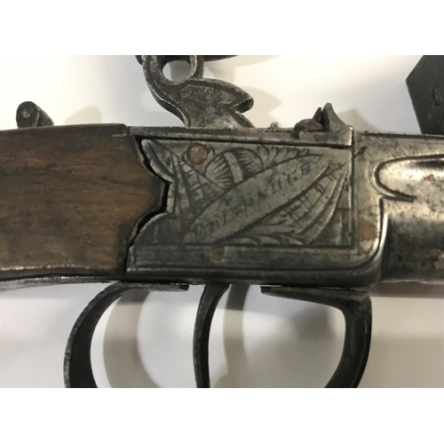 310 - A SCOTTISH FLINTLOCK POCKET PISTOL. With a round 6cm screw off barrel with underslung sprung bayonet... 