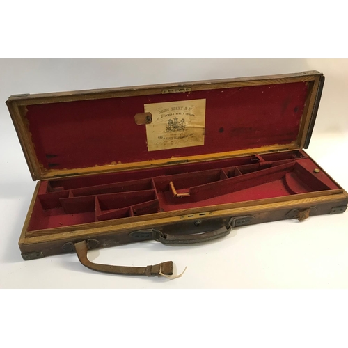 379 - A BRASS AND LEATHER GUN CASE FROM RIGBY AND CO. A case for a single gun with 30in barrels, with red ... 