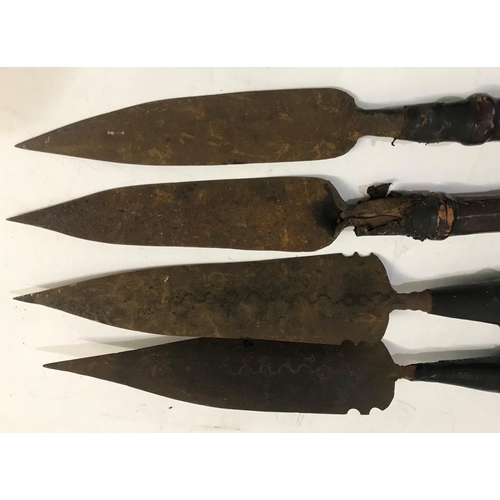 474 - A COLLECTION OF FOUR MATABELE SPEARS. Each with a flat pointed blade, two with slight engraved decor... 