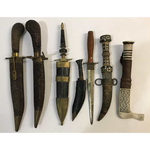 480 - A COLLECTION OF SEVEN EASTERN AND INDIAN KNIVES. An unusual bone handled knife with banded grip and ... 