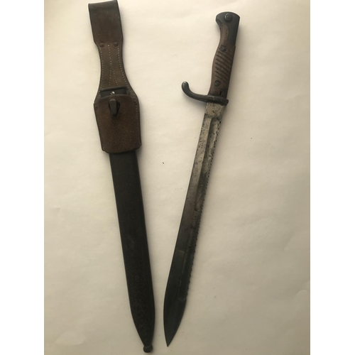 490 - A FIRST WORLD WAR MAUSER BAYONET AND SCABBARD. A First World War German 'Butcher' bayonet and scabba... 