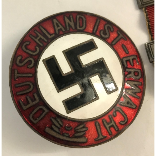 661 - A GERMAN NASDP BADGE AND OTHERS. A circular enamelled German badge with central swastika within the ... 