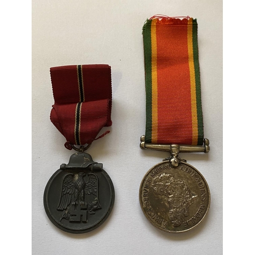 1004 - A SECOND WORLD WAR AFRICA SERVICE MEDAL AND GERMAN  EASTERN WINTER MEDAL. An Africa Service Medal 19... 