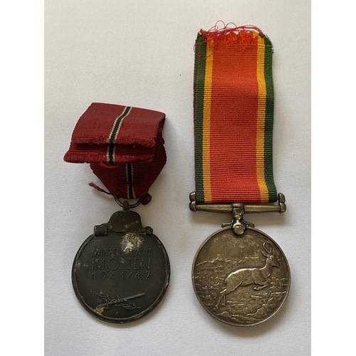 1004 - A SECOND WORLD WAR AFRICA SERVICE MEDAL AND GERMAN  EASTERN WINTER MEDAL. An Africa Service Medal 19... 