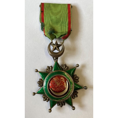 1011 - THE TURKISH ORDER OF OSMANIEH. A Turkish Empire Order of Osmanieh breast award on green and red ribb... 