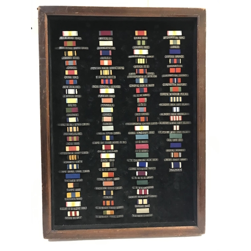 1020 - A FRAMED COLLECTION OF VICTORIAN MEDAL RIBBONS. A collection of 75 medal ribbons, including campaign... 