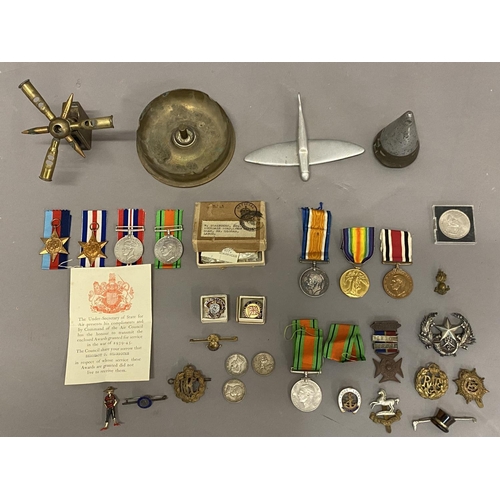 1063 - A POSSIBLE FAMILY GROUP OF FIRST AND SECOND WORLD WAR MEDALS. A Great war trio comprising War and Vi... 