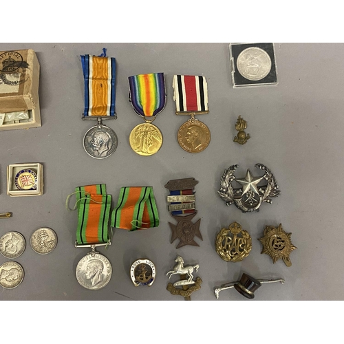 1063 - A POSSIBLE FAMILY GROUP OF FIRST AND SECOND WORLD WAR MEDALS. A Great war trio comprising War and Vi... 