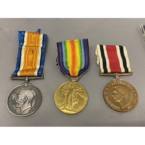 1063 - A POSSIBLE FAMILY GROUP OF FIRST AND SECOND WORLD WAR MEDALS. A Great war trio comprising War and Vi... 