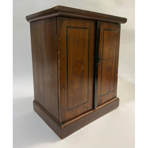 1190 - A TWO DOOR STAINED WOODEN COIN CABINET. The two doors with ebonised stringing, with twelve drawers c... 