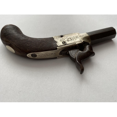 503 - A 19TH CENTURY WAISTCOAT PISTOL. A small percussion action pistol with a 3.5cm octagonal screw off b... 