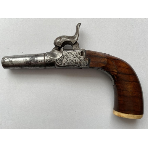 504 - A 19TH CENTURY WAISTCOAT PISTOL. A small percussion action pistol with a 3.8cm screw off barrel, the... 