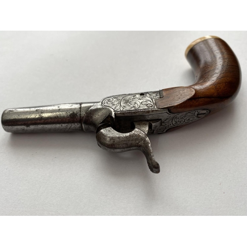 504 - A 19TH CENTURY WAISTCOAT PISTOL. A small percussion action pistol with a 3.8cm screw off barrel, the... 