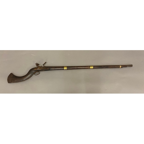 510 - A LONG BARREL JEZAIL FLINTLOCK RIFLE. With a 105cm barrel, the flintlock mechanism with a sideplate ... 