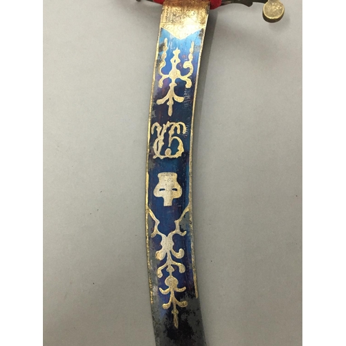 607 - AN IVORY HANDLED NAVAL DIRK. With a 36cm curved pointed blade with blued and gilt decoration of a ro... 