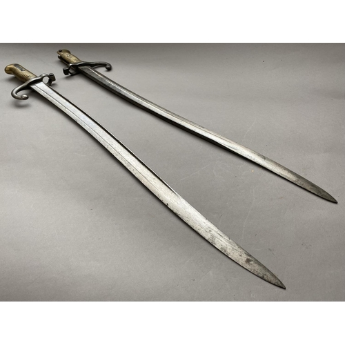 635 - TWO SIMILAR FRENCH CHASSEPOT TYPE BAYONETS. Each with 58cm curved and fullered blades, one marked to... 