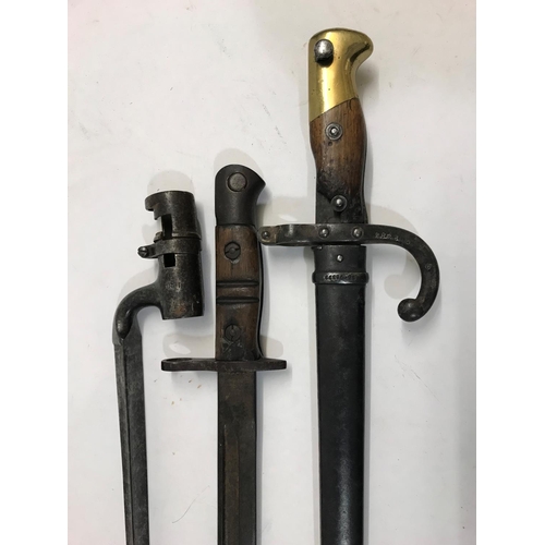 639 - A 19TH CENTURY FRENCH 'CHASSEPOT' BAYONET AND SCABBARD AND TWO OTHERS. A French bayonet with a 20.5