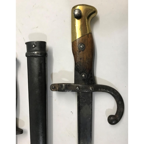 639 - A 19TH CENTURY FRENCH 'CHASSEPOT' BAYONET AND SCABBARD AND TWO OTHERS. A French bayonet with a 20.5