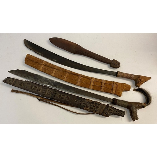 646 - TWO SIMILAR BORNEO DYACK HEAD HUNTERS SWORDS AND A CLUB. A Dyack 'Head Hunters' sword with a 54cm sh... 