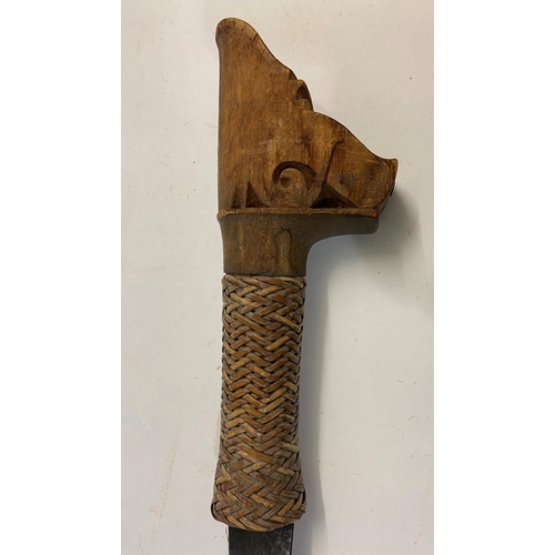 646 - TWO SIMILAR BORNEO DYACK HEAD HUNTERS SWORDS AND A CLUB. A Dyack 'Head Hunters' sword with a 54cm sh... 