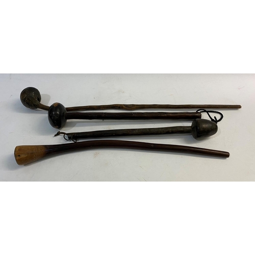 669 - FOUR SIMILAR ZULU KNOB KERRY TYPE WEAPONS. Each with rounded ends and tapering shafts, one with text... 